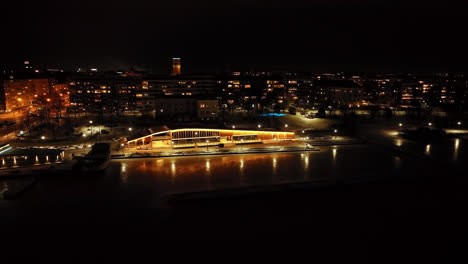 aerial rising shot around the seaside skyline of vaasa, winter evening in finland