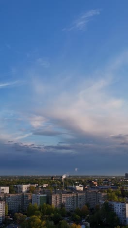vertical view of purvciems in riga, latvia, with a clear blue sky and clouds resting on the horizon.