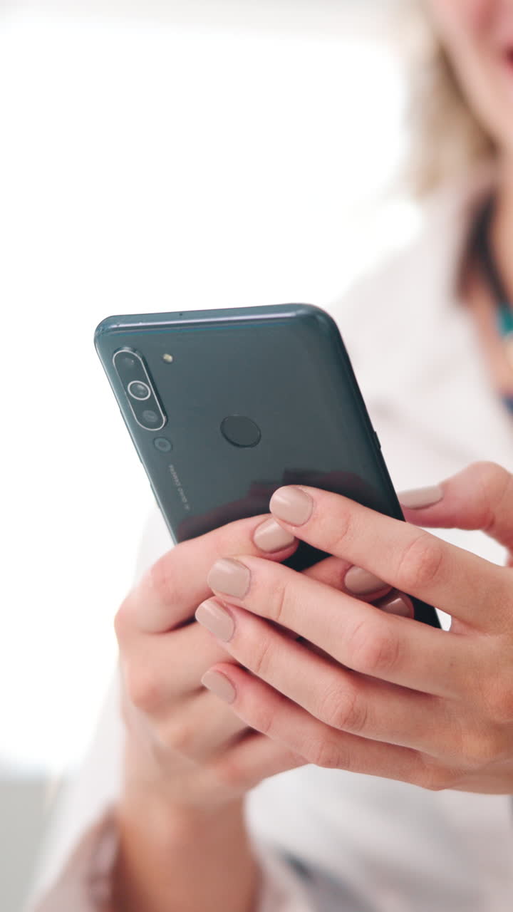 Close-up of Person's Hands Holding and Using a Smartphone