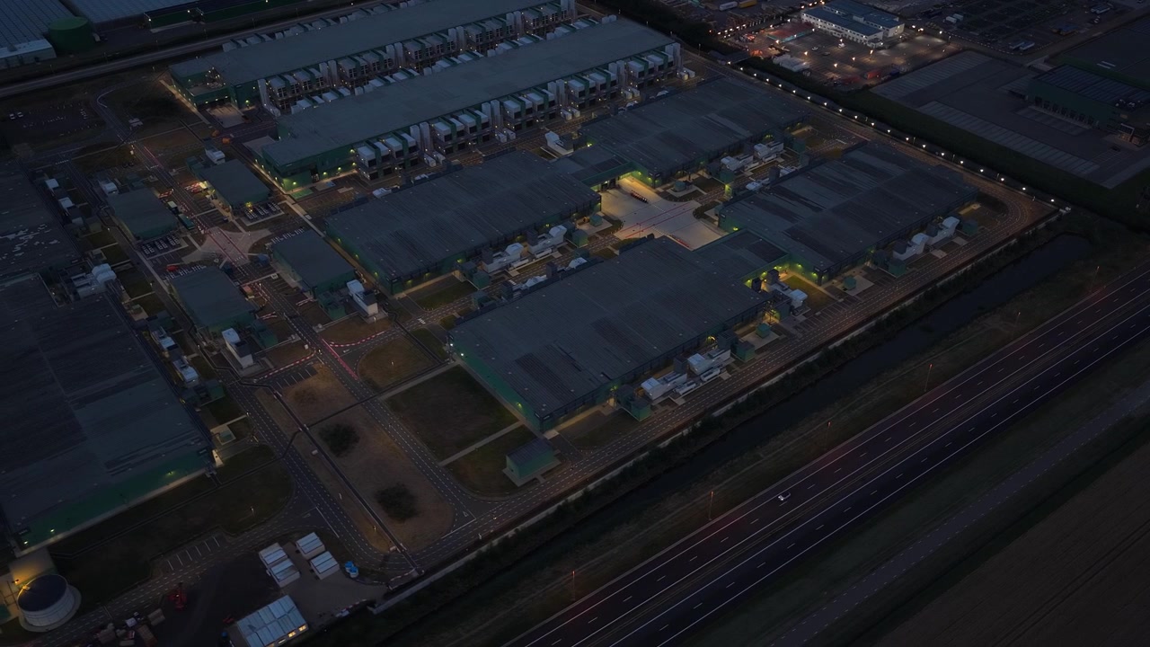 Aerial view of a modern hyperscale data center at night