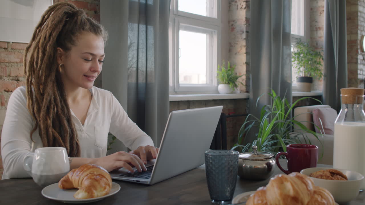 Female Freelancer Working During Breakfast