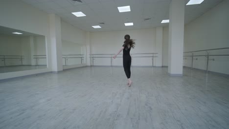 young ballerina practicing dance moves in studio