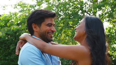 Loving-Couple-Hugging-Outdoors-In-Summer-Garden-Or-Countryside