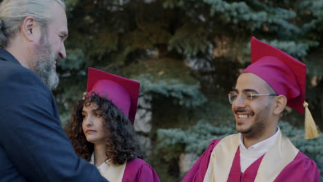 Proud Father Hugs Graduate Son at Graduation Ceremony