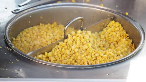 cooking corn on the cob at a street vendor