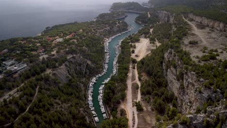 luxury yachts moored in capitainerie port-miou between the high rocks