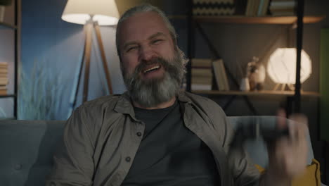 happy man playing video games at home