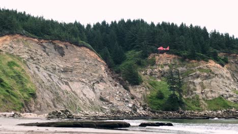 coast guard helicopter lowers a gurney for hiker that fell off a cliff on the oregon coast near coos bay