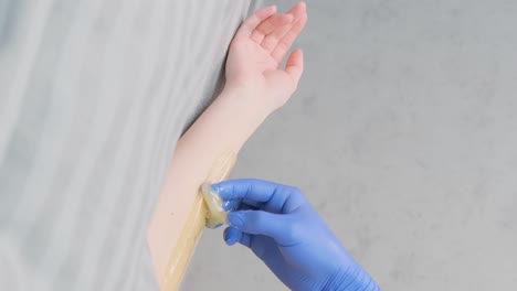 a female employee of a beauty salon waxes the body of a young beautiful girl. a female employee of a beauty salon waxes the body of a young beautiful girl. painless hair removal. video
