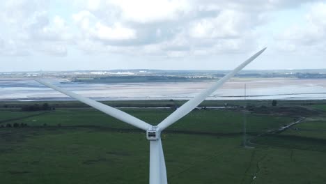 alternative green energy wind farm turbines spinning in frodsham cheshire fields aerial view descending