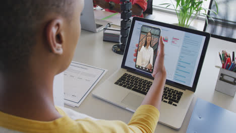 african american businesswoman using smartphone for video call with biracial business colleague