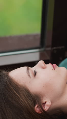 woman entrepreneur finds comfort on windowsill. rain falling outside makes tired businesswoman mind clear allowing momentarily escape worries of work