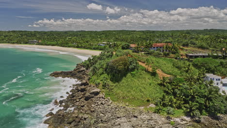 koattagoda sri lanka aerial v2 fly around hillside talalla hillside resort hotels capturing seethagalla beach with pristine sea water on a beautiful sunny day - shot with mavic 3 cine - april 2023