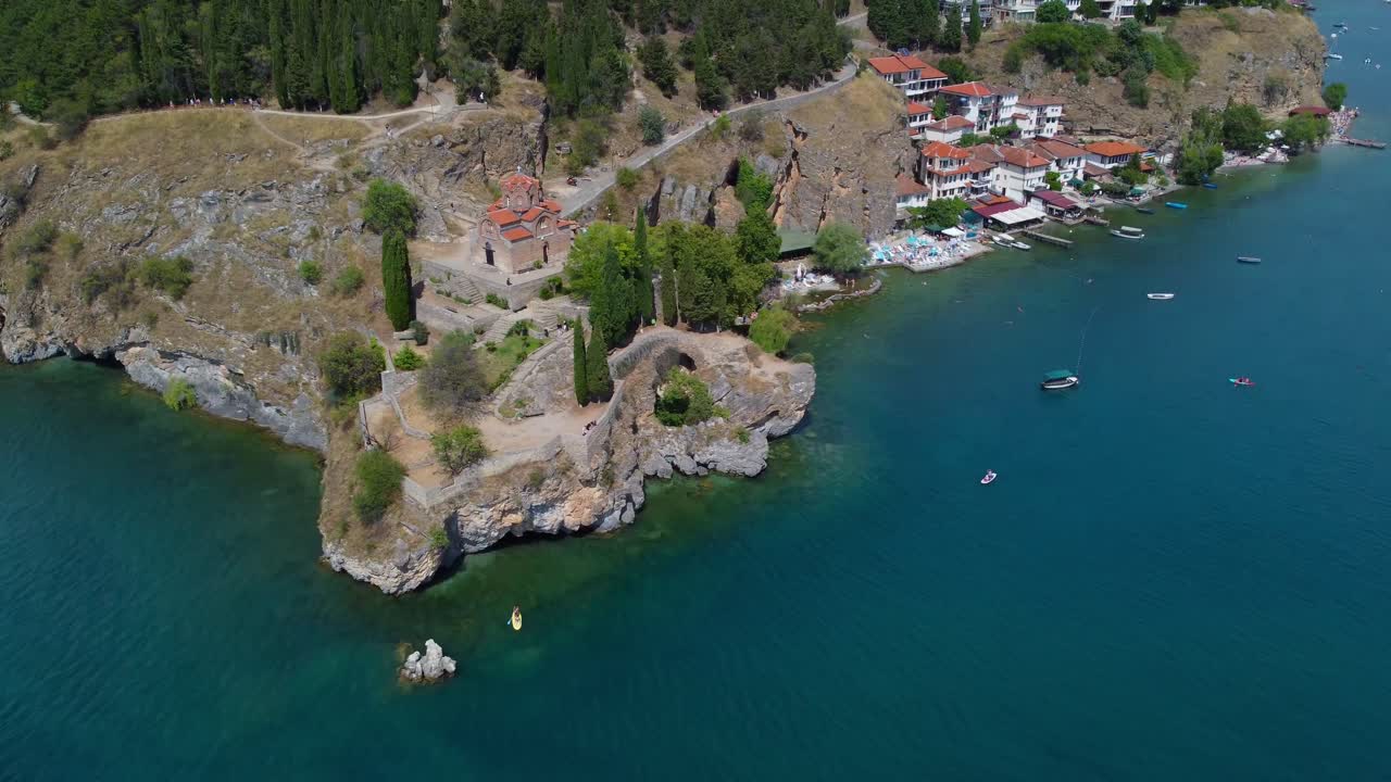 Aerial cinematic of Ohrid peninsula and St John at Kaneo church with turquoise waters on Ohrid Lake - Macedonia
