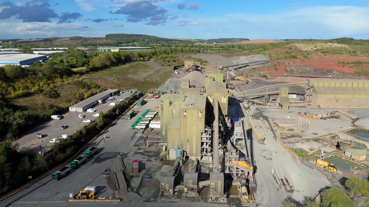 High altitude drone view of industrial quarry in Coalville England with gravel piles and excavation machinery