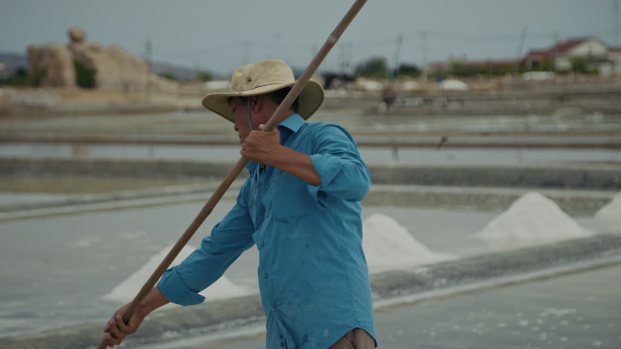 Man harvesting salt in a salt field