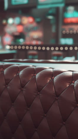 close up of a brown leather tufted booth in a restaurant