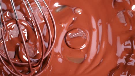 chocolate disks melting and mixing with whisk