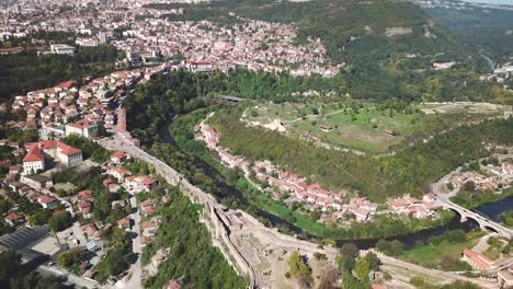 Backward,-crane-down-drone-shot-over-a-hill-with-an-archeological-site-in-Bulgaria