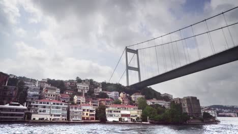 istanbul second bosphorus bridge. view of the fatih sultan mehmet bridge and residental buildings from cruise ship sailing bosporus