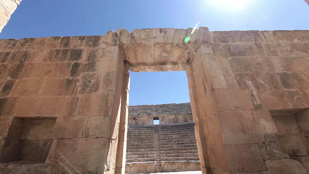 Ancient coliseum, sun flare, blue sky, Jerash, Jordan, traveling shot