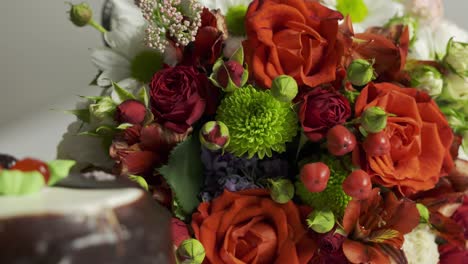 mixed flower arrangement and cake. mix of fresh flowers with red roses