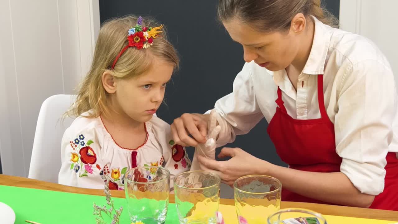 madre enseñando a su hija a poner la mesa