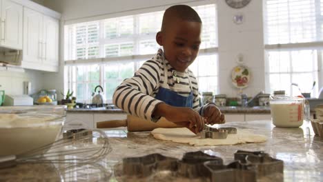 Young-boy-making-Christmas-cookies-at-home