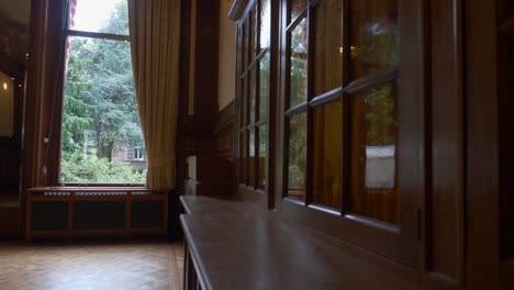 A-pan-revealing-the-insides-of-a-typical-Amsterdam-house,-with-wooden-window-frames