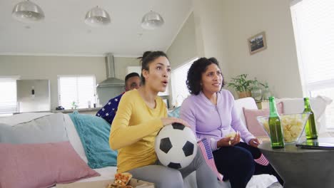 diverse female and male friends watching tv celebrating american victory in slow motion