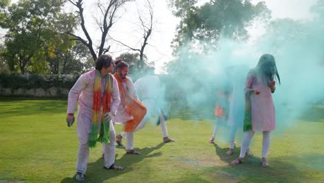 indian people throwing holi colors at each other