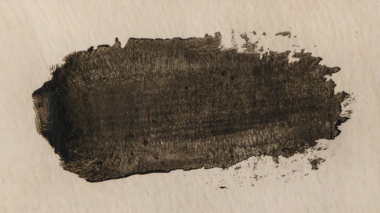 Showing fresh black stroke settling on off-white paper on desk, bristle marks and specks forming