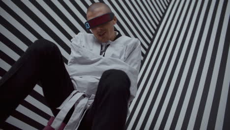 man in a straightjacket with digital glasses
