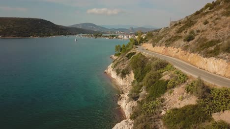 Flying-over-the-sea-next-to-the-coastline-in-Greece-during-afternoon-on-a-sunny-day