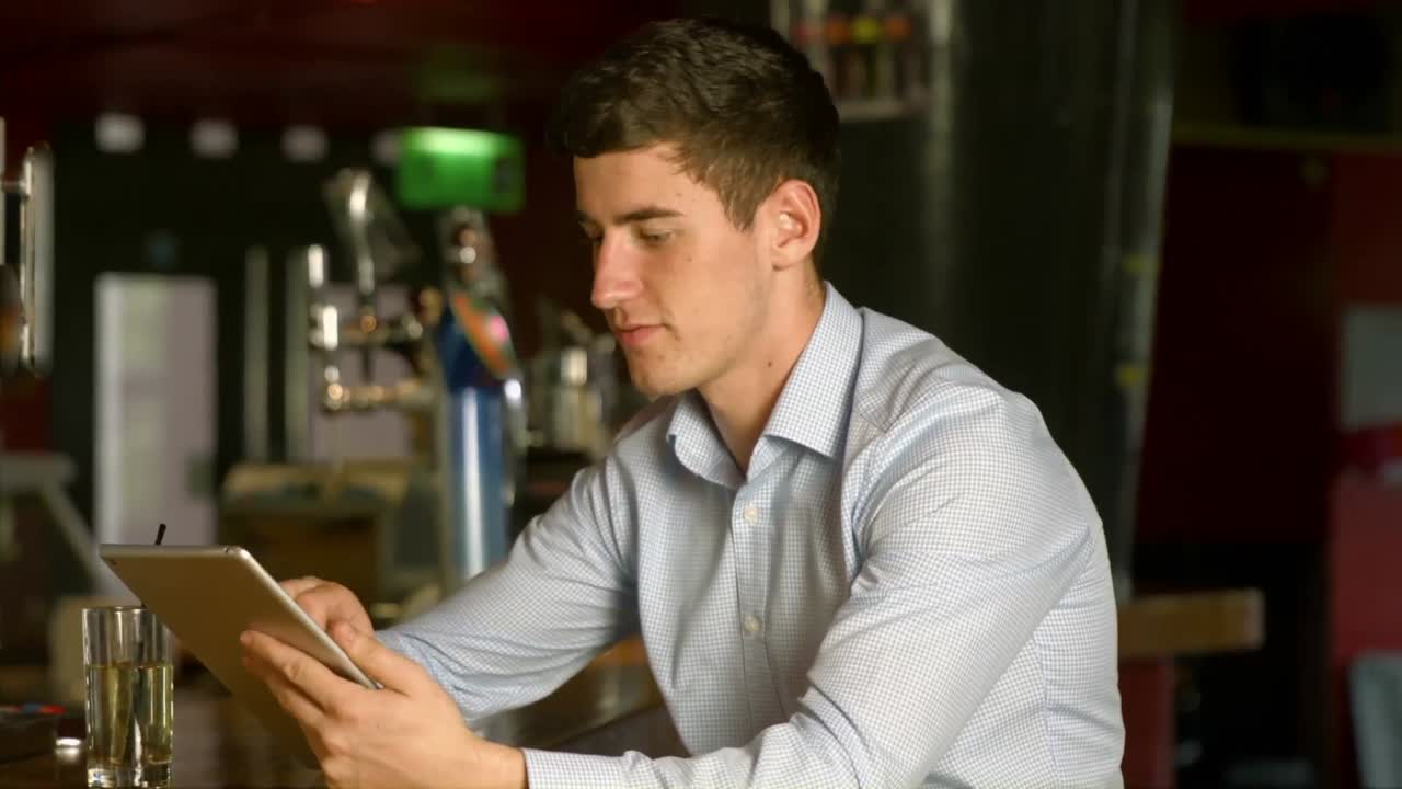 Man using tablet at the bar