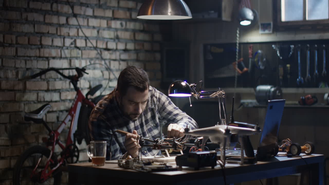 Man working on a drone in a workshop