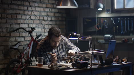 man working on a drone in a workshop