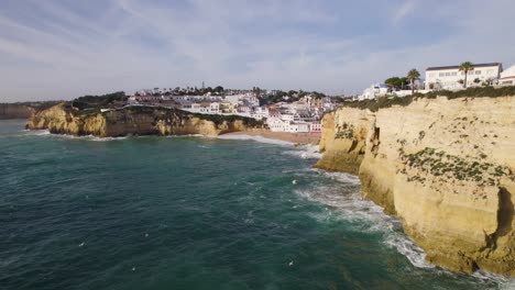 Carvoeiro-Cliffs-Overlooking-Sandy-Beach,-Portugal---aerial