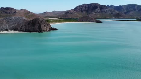 An-aerial-of-stunning-turquoise-waters-and-mountain-scenery-at-Playa-Balandra-Beach-in-Baja-California-Sur,-La-Paz,-Mexico