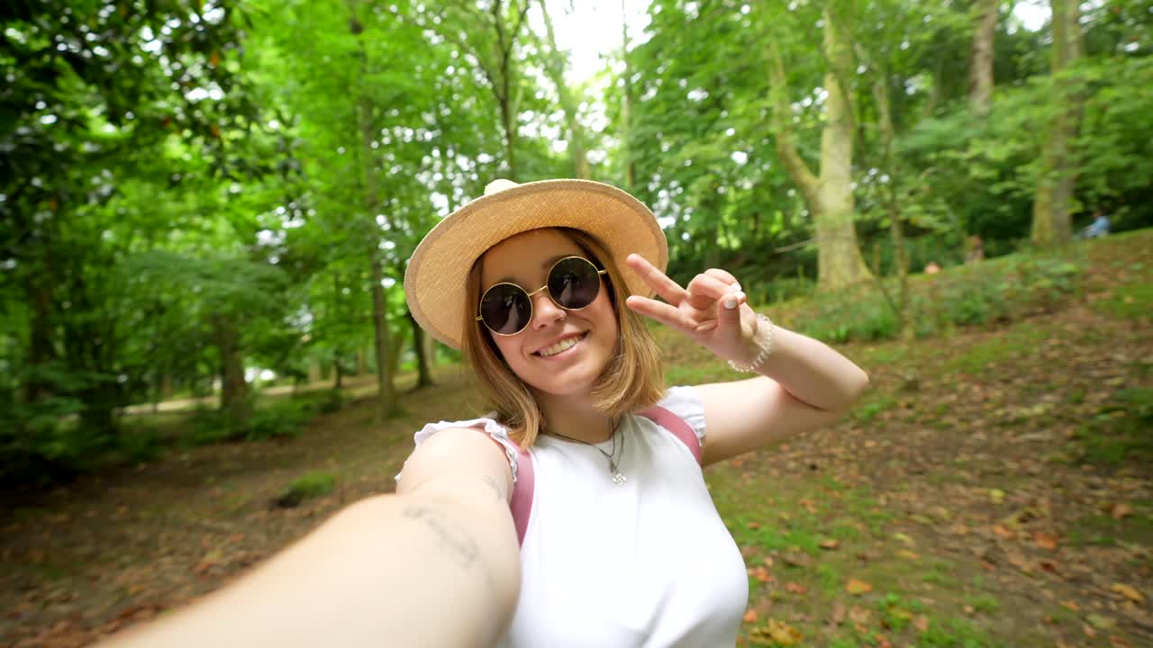 Woman taking a selfie in the forest