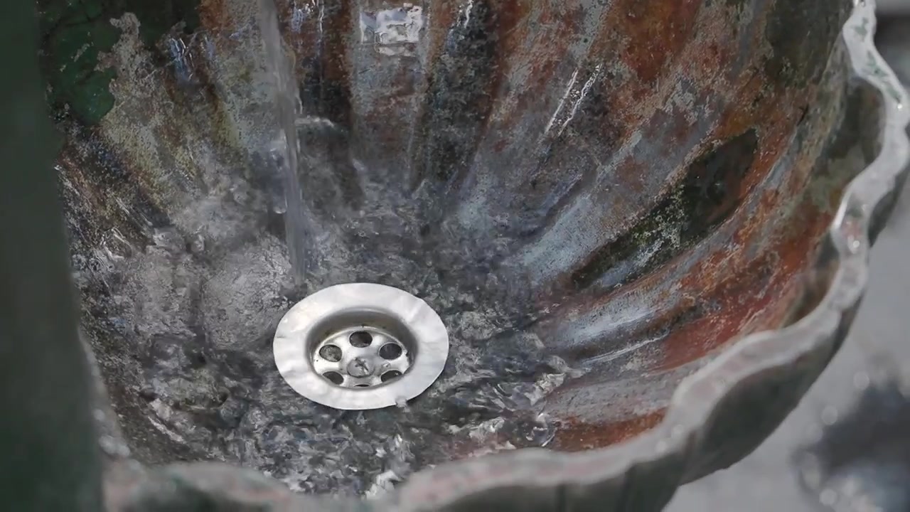 Water Flowing Into a Rustic Stone Basin