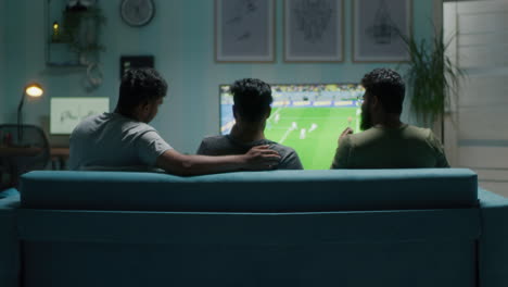 friends watching football game at home