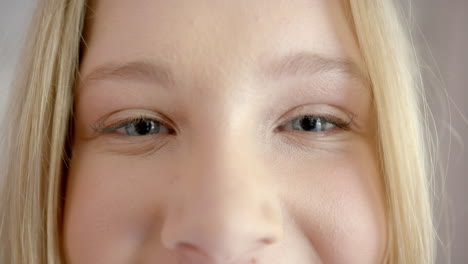 Portrait-of-happy-caucasian-female-teenager-with-blond-hair-at-home,-slow-motion