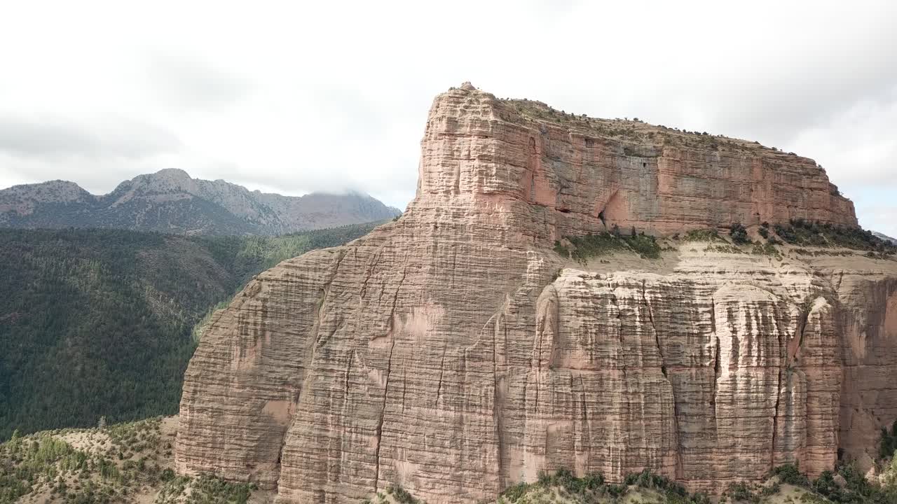Cathedral Peak stands majestically in Morocco's Atlas range, its towering limestone spires resembling Gothic cathedral towers, creating a natural sanctuary amid rugged mountain wilderness