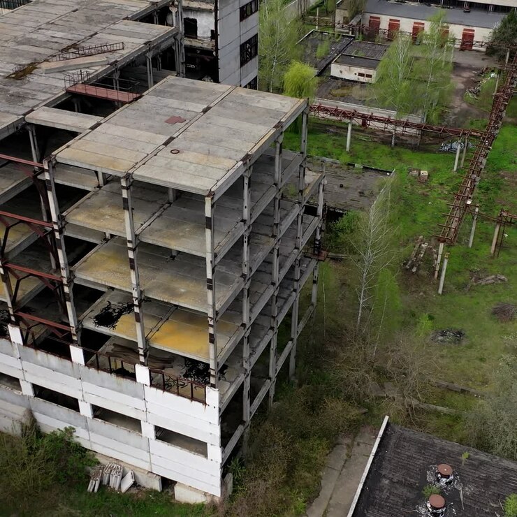 Edificio industrial en ruinas. Antigua arquitectura inacabada de una fábrica. Instalaciones de fabricación abandonadas. Vista aérea.