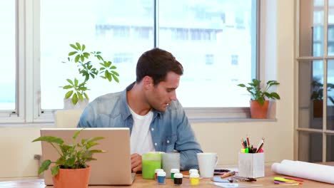 casual businessman working on laptop computer