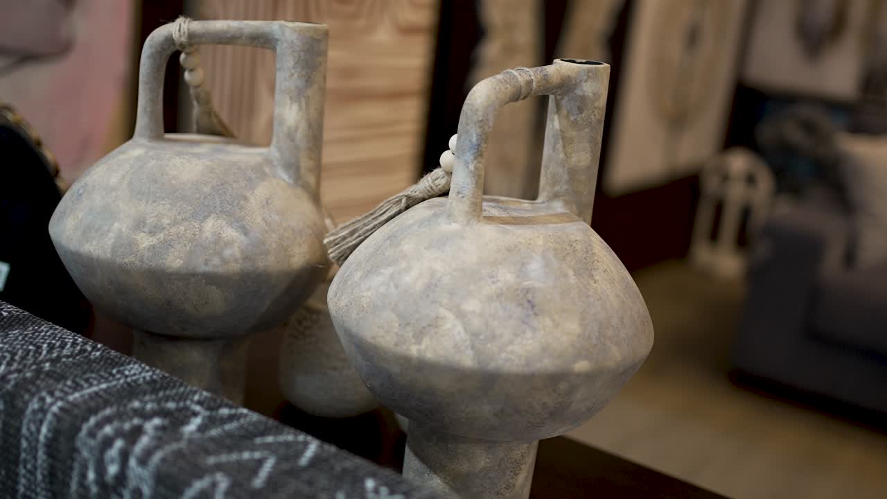 Handcrafted pottery is displayed in an art gallery featuring remarkable designs from skilled artisans. Each piece reflects the cultural heritage and creativity of the area