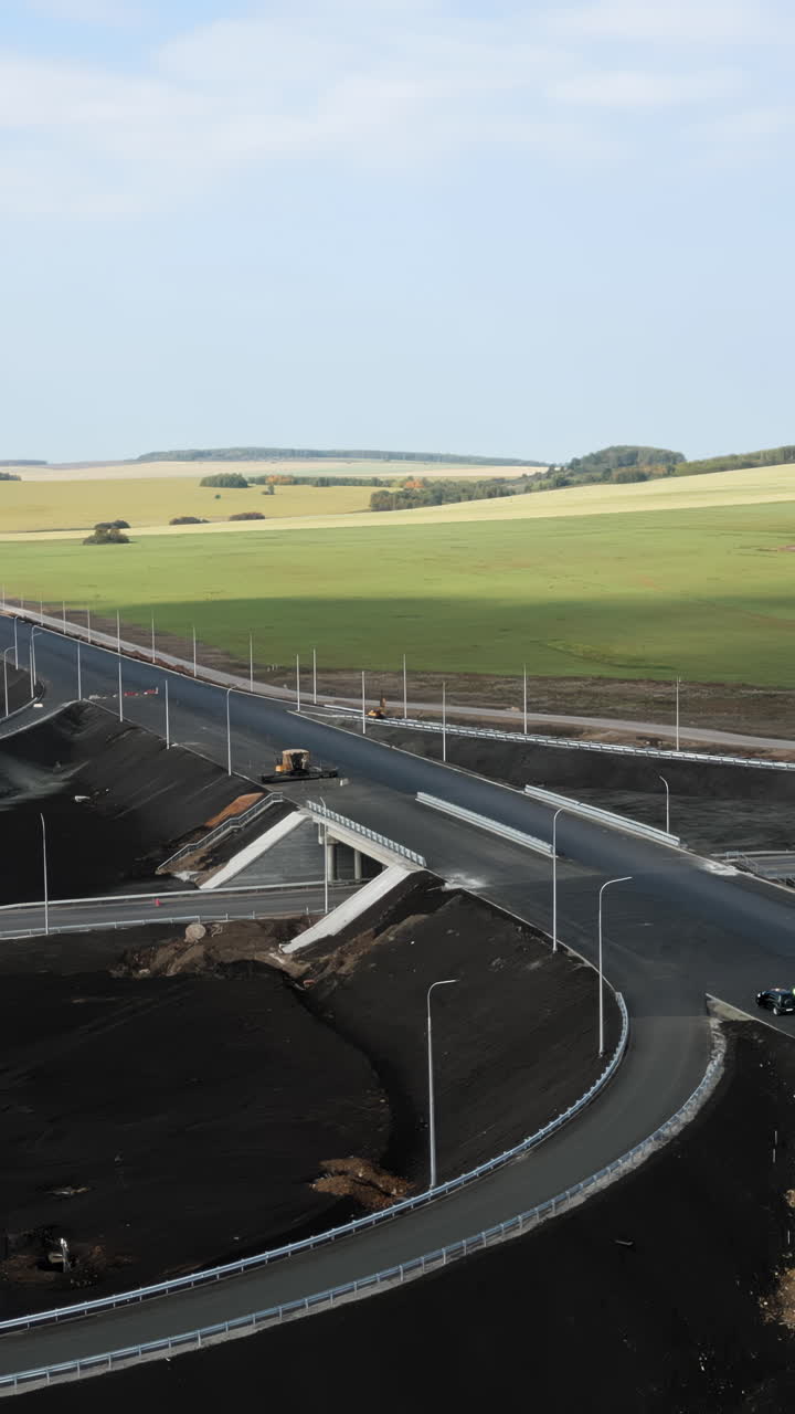 Aerial View of a Newly Constructed Highway Interchange Amidst Green Fields