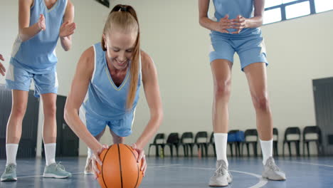 exercising with basketball, female basketball player doing push-ups in gym