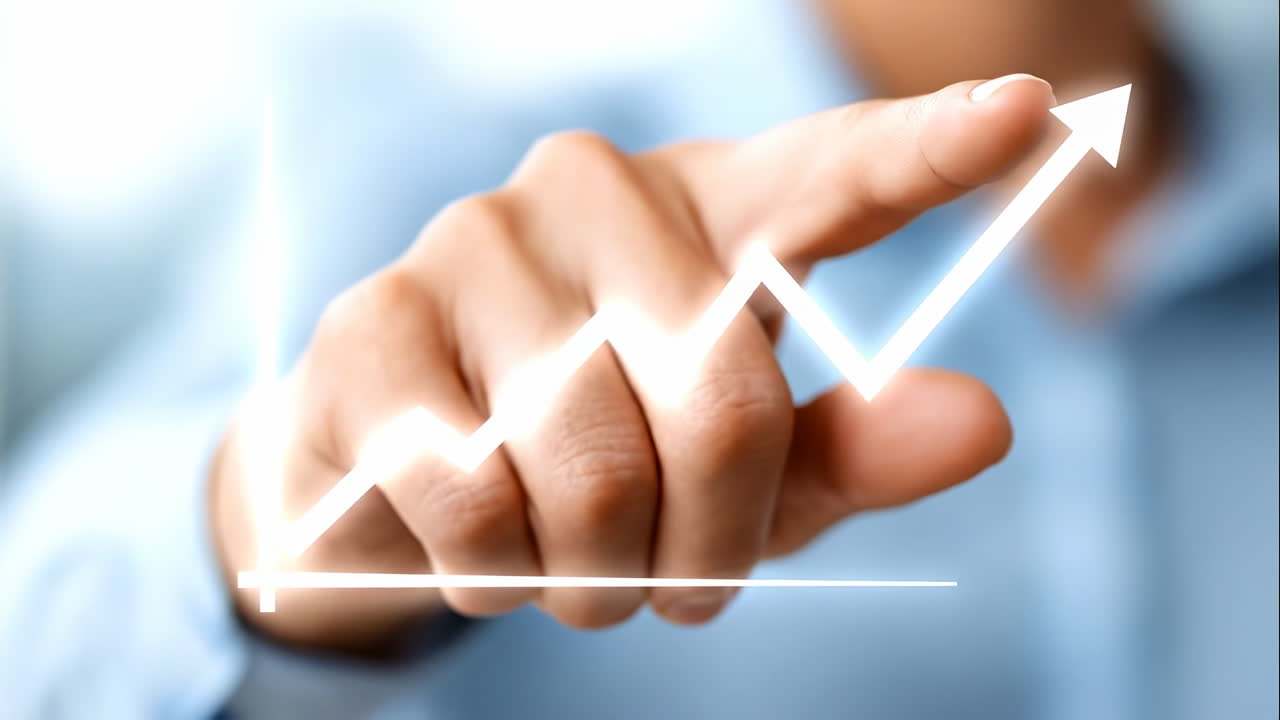 Businessman hand pointing at rising financial growth chart arrow. Close up of a finger touching a glowing white line graph with an upward arrow on a blurred blue background